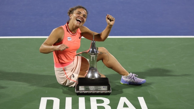 DUBAI, UNITED ARAB EMIRATES - FEBRUARY 24: Jasmine Paolini of Italy Anna Kalinskaya poses with her winners trophy after victory against  Anna Kalinskaya in their Women's Singles Final match during the Dubai Duty Free Tennis Championships, part of the Hologic WTA Tour at Dubai Duty Free Tennis Stadium on February 24, 2024 in Dubai, United Arab Emirates. (Photo by Francois Nel/Getty Images)