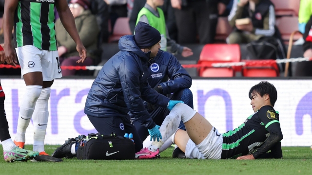 SHEFFIELD, ENGLAND - FEBRUARY 18: Kaoru Mitoma of Brighton & Hove Albion receives medical treatment after being fouled by Mason Holgate of Sheffield United (not pictured), which leads to a red card during the Premier League match between Sheffield United and Brighton & Hove Albion at Bramall Lane on February 18, 2024 in Sheffield, England. (Photo by Matt McNulty/Getty Images)