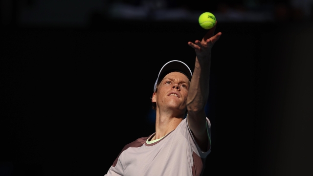 MELBOURNE, AUSTRALIA - JANUARY 26: Jannik Sinner of Italy serves in their Semifinal singles match against Novak Djokovic of Serbia during the 2024 Australian Open at Melbourne Park on January 26, 2024 in Melbourne, Australia. (Photo by Daniel Pockett/Getty Images)