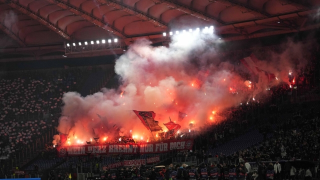 Bayern supporters light flares prior to the start of the Champions League round of 16 first leg soccer match between Lazio and Bayern Munich, at Rome's Olympic Stadium, Wednesday, Feb. 14, 2024. (AP Photo/Andrew Medichini)