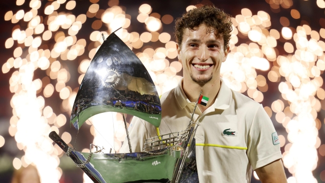 DUBAI, UNITED ARAB EMIRATES - MARCH 02: Ugo Humbert of France celebrates victory with the trophy over Alexander Bublik of Kazakhstan in the final match during the Dubai Duty Free Tennis Championships at Dubai Duty Free Tennis Stadium on March 02, 2024 in Dubai, United Arab Emirates. (Photo by Christopher Pike/Getty Images)