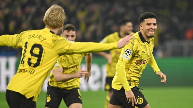 Dortmund's English midfielder #10 Jadon Sancho (R) celebrates after scoring the opening 1-0 goal during the UEFA Champions League last 16, second-leg football match BVB Borussia Dortmund v PSV Eindhoven at the Signal Iduna stadium in Dortmund, western Germany on March 13, 2024. (Photo by INA FASSBENDER / AFP)