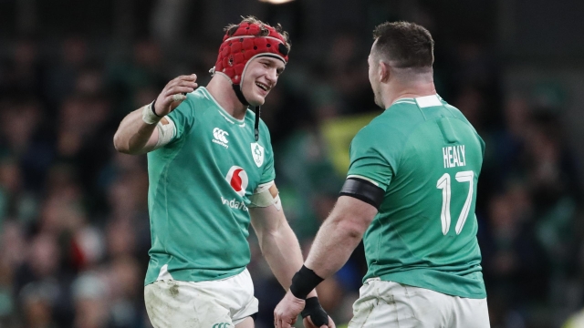 Ireland's Josh Van der Flier , left and teammate Ireland's Cian Healy celebrate after the end of the Six Nations international rugby union match between Ireland and Scotland, at the Aviva stadium in Dublin, Ireland, Saturday, March 16, 2024. Ireland have won the Six Nations championship. (AP Photo/Peter Morrison)