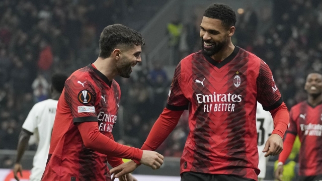 AC Milan's Ruben Loftus-Cheek celebrates with his teammate Christian Pulisic after scoring his side's second goal during the Europa League play-off first leg soccer match between AC Milan and Rennes at the San Siro Stadium, in Milan, Italy, Thursday, Feb. 15, 2024. (AP Photo/Antonio Calanni)