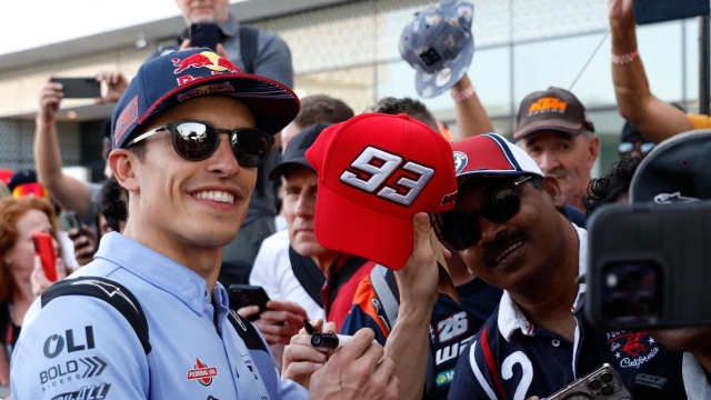 Gresini Racing MotoGP Spanish rider Marc Marquez poses with fans during the 'MotoGP VIP Village Pit Lane Walk' ahead of the Qatar MotoGP Grand Prix at the Lusail International Circuit in Lusail, north of Doha on March 10, 2024. (Photo by KARIM JAAFAR / AFP)