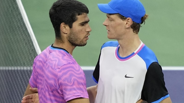 Carlos Alcaraz, of Spain, left, embraces Jannik Sinner, of Italy, after defeating him in a semifinal match at the BNP Paribas Open tennis tournament, Saturday, March 16, 2024, in Indian Wells, Calif. (AP Photo/Mark J. Terrill)