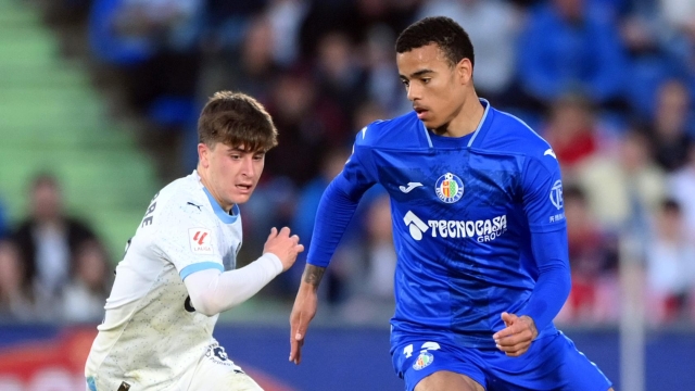 GETAFE, SPAIN - MARCH 16: Mason Greenwood of Getafe CF runs with the ball under pressure from Pablo Torre of Girona FC during the LaLiga EA Sports match between Getafe CF and Girona FC at Coliseum Alfonso Perez on March 16, 2024 in Getafe, Spain. (Photo by Denis Doyle/Getty Images)