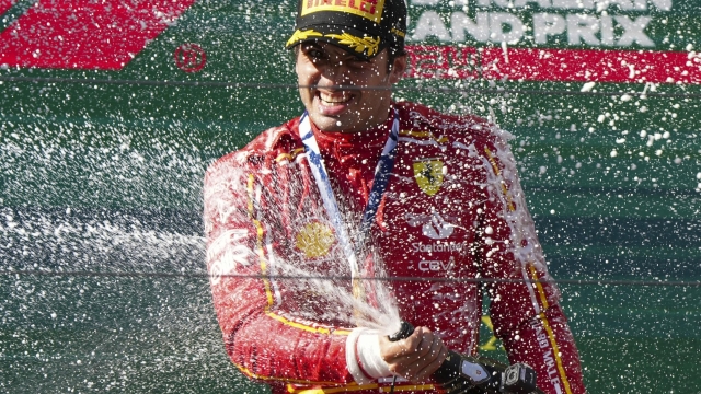 Ferrari driver Carlos Sainz of Spain sprays champagne after winning the Australian Formula One Grand Prix at Albert Park, in Melbourne, Australia, Sunday, March 24, 2024. (AP Photo/Asanka Brendon Ratnayake)