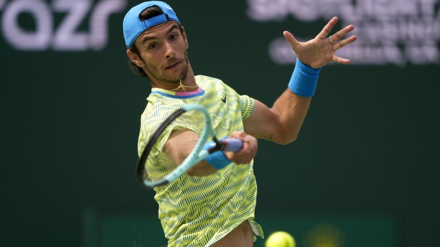 Lorenzo Musetti, of Italy, returns a shot against Holger Rune, of Denmark, at the BNP Paribas Open tennis tournament in Indian Wells, Calif., Monday, March 11, 2024. (AP Photo/Ryan Sun)