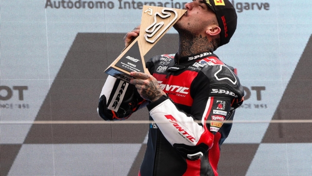 epa11241065 Aron Canet of Spain and Fantic Racing celebrates winning on the podium for the Moto2 race of the Motorcycling Grand Prix of Portugal, in Portimao, Portugal, 24 March 2024.  EPA/JOSE SENA GOULAO