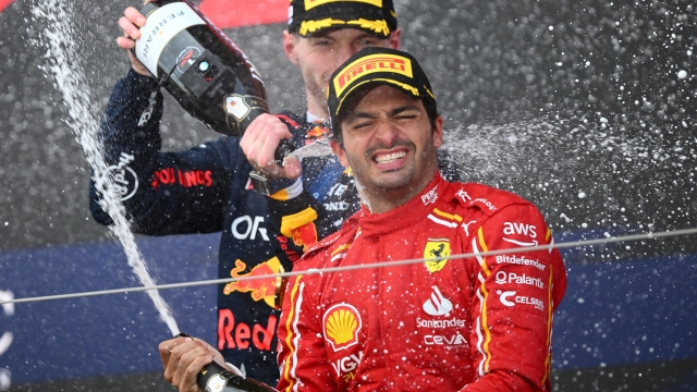 SUZUKA, JAPAN - APRIL 07: Race winner Max Verstappen of the Netherlands and Oracle Red Bull Racing and Third placed Carlos Sainz of Spain and Ferrari celebrate on the podium during the F1 Grand Prix of Japan at Suzuka International Racing Course on April 07, 2024 in Suzuka, Japan. (Photo by Clive Mason/Getty Images)