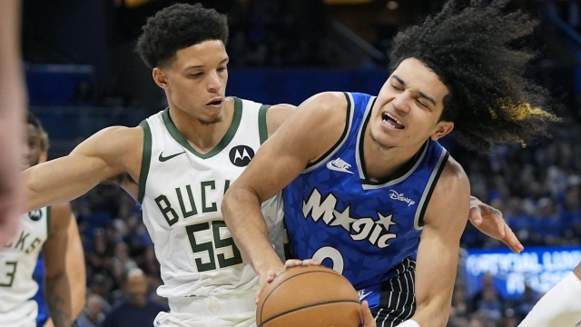 Orlando Magic guard Anthony Black, right collides with Milwaukee Bucks guard Ryan Rollins (55) while driving to the basket during the second half of an NBA basketball game, Sunday, April 14, 2024, in Orlando, Fla. (AP Photo/John Raoux)