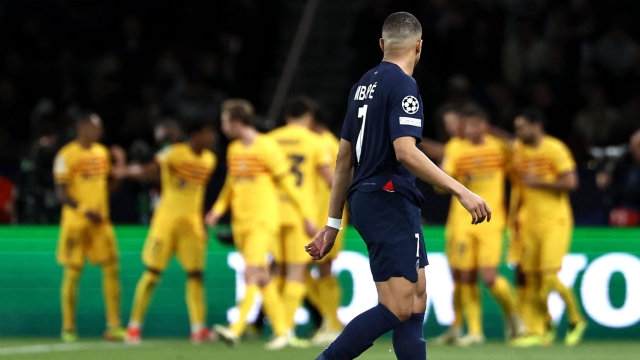 Paris Saint-Germain's French forward #07 Kylian Mbappe (C) reacts after Barcelona scored their first goal during the UEFA Champions League quarter final first leg football match between Paris Saint-Germain (PSG) and FC Barcelona at the Parc des Princes stadium in Paris on April 10, 2024. (Photo by FRANCK FIFE / AFP)