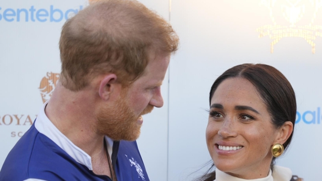 Meghan Markle, Duchess of Sussex, looks up at her husband, Britain's Prince Harry, during the prize ceremony for the 2024 Royal Salute Polo Challenge to Benefit Sentebale, Friday, April 12, 2024, in Wellington, Fla. Prince Harry, co-founding patron of the Sentebale charity, will play on the Royal Salute Sentebale Team. (AP Photo/Rebecca Blackwell)