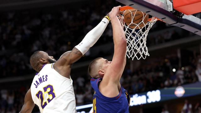 DENVER, COLORADO - APRIL 20: Nikola Jokic #15 of the Denver Nuggets dunks on LeBron James #23 of the Los Angeles Lakers in the fourth quarter during game one of the Western Conference First Round Playoffs at Ball Arena on April 20, 2024 in Denver, Colorado. NOTE TO USER: User expressly acknowledges and agrees that, by downloading and or using this photograph, User is consenting to the terms and conditions of the Getty Images License Agreement.   Matthew Stockman/Getty Images/AFP (Photo by MATTHEW STOCKMAN / GETTY IMAGES NORTH AMERICA / Getty Images via AFP)