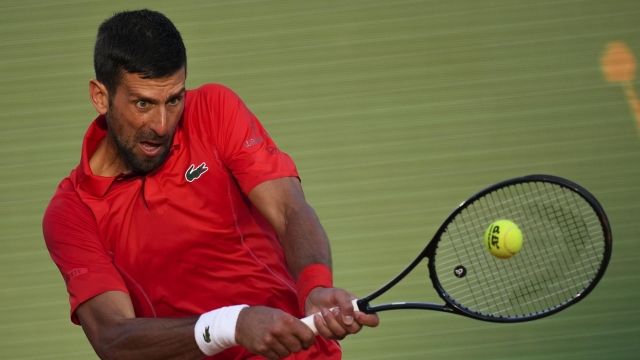 Serbia's Novak Djokovic returns the ball to Casper Ruud, of Norway during a semifinals match at the Monte Carlo Tennis Masters tournament in Monaco, Saturday, April 13, 2024. (AP Photo/Daniel Cole)