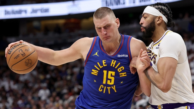 DENVER, COLORADO - APRIL 20: Nikola Jokic #15 of the Denver Nuggets drives against Anthony Davis #3 of the Los Angeles Lakers in the third quarter during game one of the Western Conference First Round Playoffs at Ball Arena on April 20, 2024 in Denver, Colorado. NOTE TO USER: User expressly acknowledges and agrees that, by downloading and or using this photograph, User is consenting to the terms and conditions of the Getty Images License Agreement.   Matthew Stockman/Getty Images/AFP (Photo by MATTHEW STOCKMAN / GETTY IMAGES NORTH AMERICA / Getty Images via AFP)