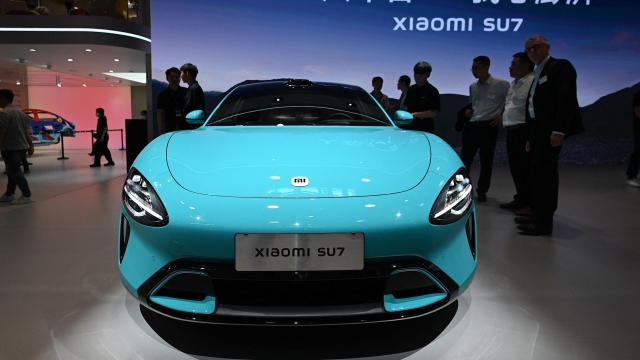 A Xiaomi SU7 model electric car is displayed at the Beijing Auto Show in Beijing on April 25, 2024. (Photo by Jade Gao / AFP)