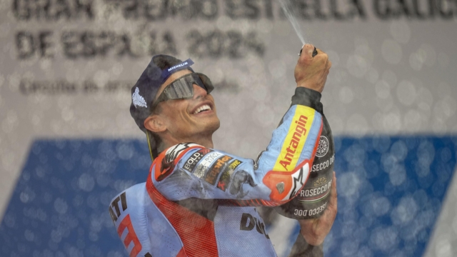 Second placed Spain's rider Marc Marquez of the Gresini Racing MotoGP sprays champagne on the podium after the MotoGP race of the Spanish Motorcycle Grand Prix at the Angel Nieto racetrack in Jerez de la Frontera, Spain, Sunday, April 28, 2024. (AP Photo/Jose Breton)