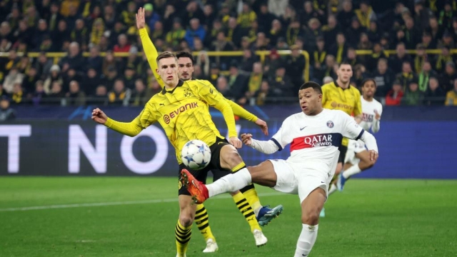 DORTMUND, GERMANY - DECEMBER 13: Nico Schlotterbeck of Borussia Dortmund and Kylian Mbappe of Paris Saint-Germain battle for possession during the UEFA Champions League match between Borussia Dortmund and Paris Saint-Germain at Signal Iduna Park on December 13, 2023 in Dortmund, Germany. (Photo by Alex Grimm/Getty Images)