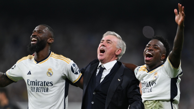 MADRID, SPAIN - MAY 08: Antonio Rudiger, Head coach Carlo Ancelotti and Vinicius Jr. of Real Madrid CF celebrate at the end of the UEFA Champions League semi-final second leg match between Real Madrid and FC Bayern München at Estadio Santiago Bernabeu on May 08, 2024 in Madrid, Spain. (Photo by David Ramos/Getty Images)