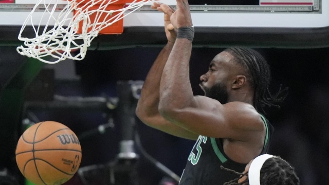 Boston Celtics guard Jaylen Brown, top, dunks over Indiana Pacers center Myles Turner (33) during the first half of Game 2 of the NBA Eastern Conference basketball finals Thursday, May 23, 2024, in Boston. (AP Photo/Steven Senne)