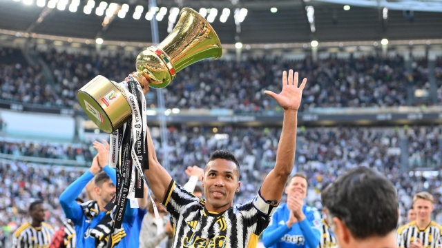 Juventus' Alex Sandro celebrates with the Coppa Italia trophy (won against Atalanta BC on 15 May 2024) at the end of the Italian Serie A soccer match Juventus FC vs AC Monza at the Allianz Stadium in Turin, Italy, 25 May 2024. ANSA/ALESSANDRO DI MARCO