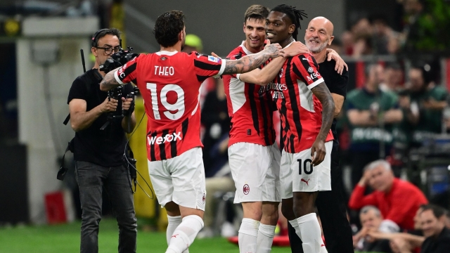 AC Milan's Portuguese forward #10 Rafael Leao (2nd R) celebrates with AC Milan's Italian coach Stefano Pioli (R) and teammates after scoring his team's opening goal during the Italian Serie A football match between AC Milan and Salernitana at San Siro Stadium, in Milan on May 25, 2024.  as the last match by coach (Photo by MARCO BERTORELLO / AFP)