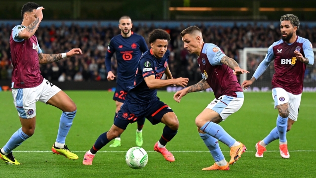 BIRMINGHAM, ENGLAND - APRIL 11: Tiago Santos of Lille runs with the ball whilst under pressure from Lucas Digne of Aston Villa during the UEFA Europa Conference League 2023/24 Quarter-final first leg match between Aston Villa and Lille OSC at Villa Park on April 11, 2024 in Birmingham, England. (Photo by Shaun Botterill/Getty Images)