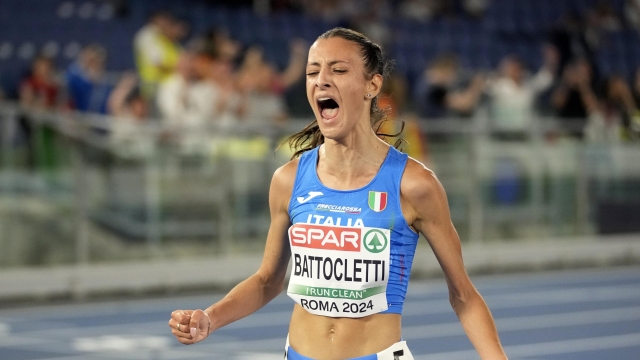 Nadia Battocletti, of Italy, celebrates crossing the finish line to win the women's 5000 meters final at the the European Athletics Championships in Rome, Friday, June 7, 2024. (AP Photo/Andrew Medichini)