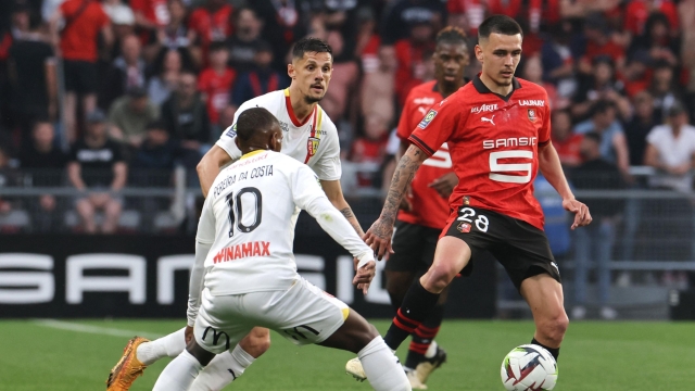 Rennes' French midfielder #28 Enzo Le Fee fights for the ball with Lens' French midfielder #11 Angelo Fulgini and Lens' Portuguese midfielder #10 David Pereira da Costa during the French L1 football match between Stade Rennais FC and RC Lens at the Roazhon Park stadium in Rennes, western France, on May 12, 2024. (Photo by FRED TANNEAU / AFP)