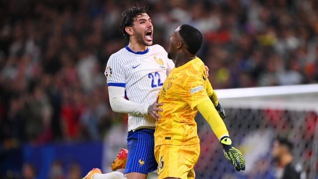 HAMBURG, GERMANY - JULY 05: Theo Hernandez of France celebrates scoring the team's fifth and winning penalty in the penalty shoot out with teammate Mike Maignan during the UEFA EURO 2024 quarter-final match between Portugal and France at Volksparkstadion on July 05, 2024 in Hamburg, Germany. (Photo by Stu Forster/Getty Images)