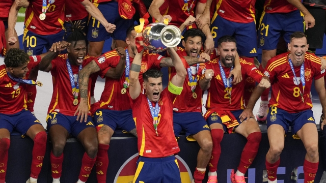 Spain's Alvaro Morata lifts the trophy after winning the final match between Spain and England at the Euro 2024 soccer tournament in Berlin, Germany, Sunday, July 14, 2024. (AP Photo/Andreea Alexandru)