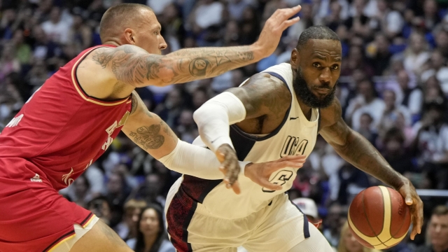 Germany's forward Daniel Theis, left, blocks United States' forward LeBron James during an exhibition basketball game between the United States and Germany at the O2 Arena in London, Monday, July 22, 2024. (AP Photo/Alastair Grant)