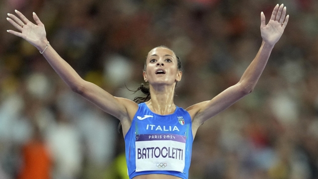 Nadia Battocletti, of Italy, celebrates after winning the silver medal in the women's 10000 meters final at the 2024 Summer Olympics, Friday, Aug. 9, 2024, in Saint-Denis, France. (AP Photo/Ashley Landis)