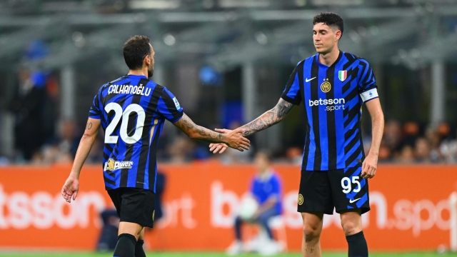 MILAN, ITALY - AUGUST 24:  Hakan Calhanoglu of FC Internazionale reacts with Alessandro Bastoni during the Serie match between Inter and Lecce at Stadio Giuseppe Meazza on August 24, 2024 in Milan, Italy. (Photo by Mattia Pistoia - Inter/Inter via Getty Images)