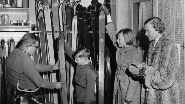 January 1957:  A family selects skis in a shop in Zermatt.  (Photo by Hulton Archive/Getty Images)