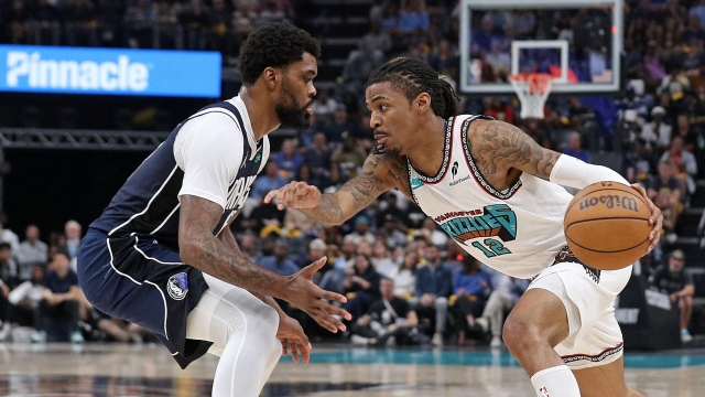 Ja Morant #12 of the Memphis Grizzlies handles the ball against Naji Marshall #13 of the Dallas Mavericks during the second half of the Play-In Tournament at FedExForum on April 18, 2025 in Memphis, Tennessee. NOTE TO USER: User expressly acknowledges and agrees that, by downloading and or using this photograph, User is consenting to the terms and conditions of the Getty Images License Agreement. Justin Ford/Getty Images/AFP (Photo by Justin Ford / GETTY IMAGES NORTH AMERICA / Getty Images via AFP)