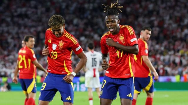 Nico Williams of Spain celebrates scoring his team's third goal with teammate Lamine Yamal during the UEFA EURO 2024 round of 16 match between Spain and Georgia at Cologne Stadium on June 30, 2024 in Cologne, Germany. (Photo by Alex Grimm/Getty Images)
