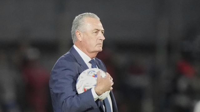 Paraguay's coach Gustavo Alfaro holds a ball during a World Cup 2026 qualifying soccer match against Ecuador at Defensores del Chaco in Asuncion, Paraguay, Thursday, Sept. 4, 2025. (AP Photo/Jorge Saenz)