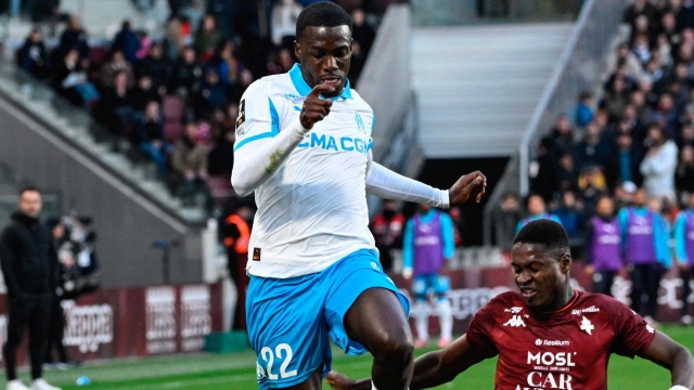 Timothy Weah in action for Marseille, fighting for the ball against Sadibou Sane of Metz.