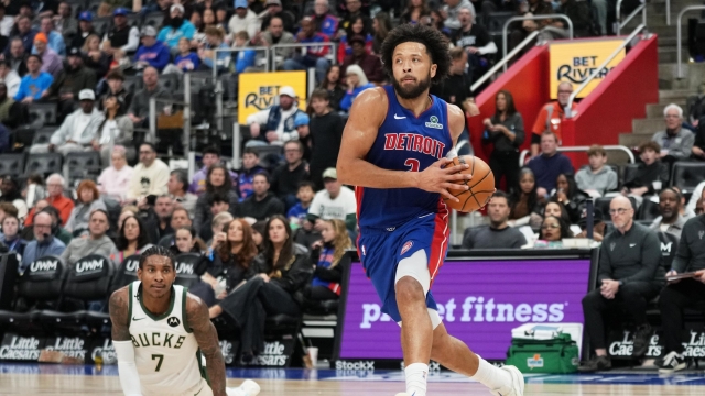 Detroit Pistons guard Cade Cunningham, right, drives past Milwaukee Bucks guard Kevin Porter Jr. (7) during the second half of an NBA basketball game Saturday, Dec. 6, 2025, in Detroit. (AP Photo/Ryan Sun)