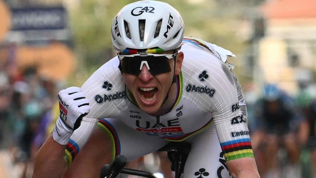 UAE Team Emirate's Slovenian rider Tadej Pogacar celebrates as he crosses the finish line to win the 117th Milan - Sanremo one-day classic cycling race, in Sanremo on March 21, 2026. (Photo by Marco BERTORELLO / AFP)