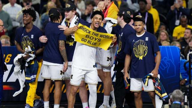 Michigan forward Yaxel Lendeborg holds a sign as he celebrates after defeating UConn in the NCAA college basketball tournament national championship game at the Final Four, Monday, April 6, 2026, in Indianapolis. (AP Photo/AJ Mast)