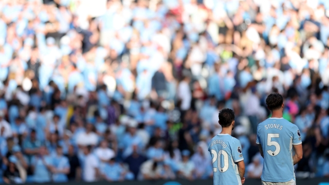  Bernardo Silva of Manchester City and John Stones of Manchester City looks on during the award ceremony following the Premier League match between Manchester City and Aston Villa at the Etihad Stadium on May 24, 2026 in Manchester, England. (Photo by Carl Recine/Getty Images)