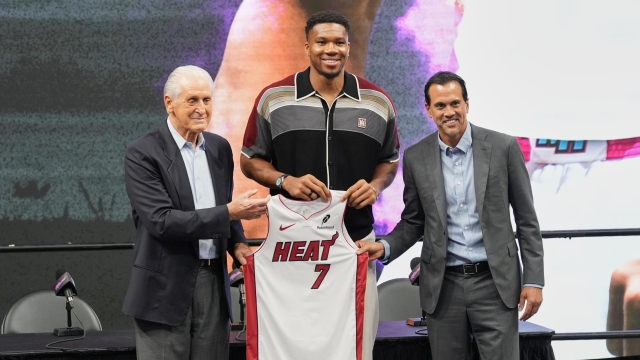 Miami Heat President Pat Riley, left, head coach Erik Spoelstra, right, stand with Giannis Antetokounmpo as he is introduced to the team Thursday, July 16, 2026, in Miami. (AP Photo/Marta Lavandier)