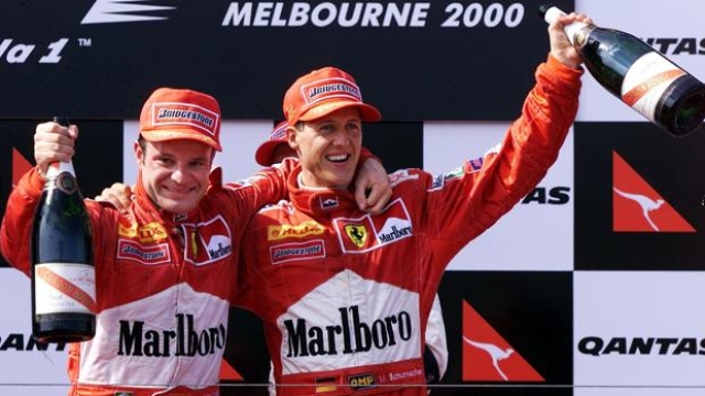 Rubens Barrichello e Michael Schumacher festeggiano il loro primo podio insieme in Ferrari. Afp