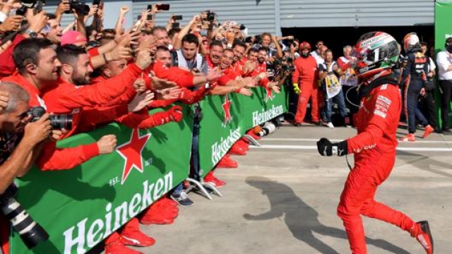 Leclerc esulta con i meccanici Ferrari dopo la vittoria a Monza.Afp