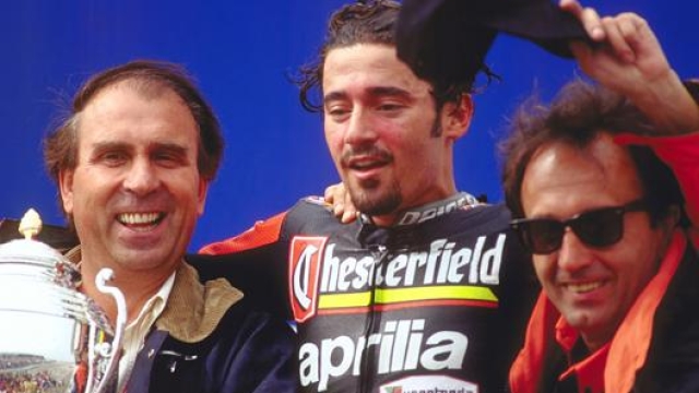 Beggio con Max Biaggi e Carlo Pernat sul podio di una delle tante vittorie mondiali del pilota romano con l’Aprilia