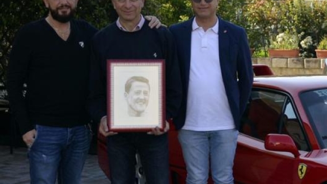 Andrea Poeta, primo da sinistra, con il ritratto di Schumi consegnato poi al figlio Mick